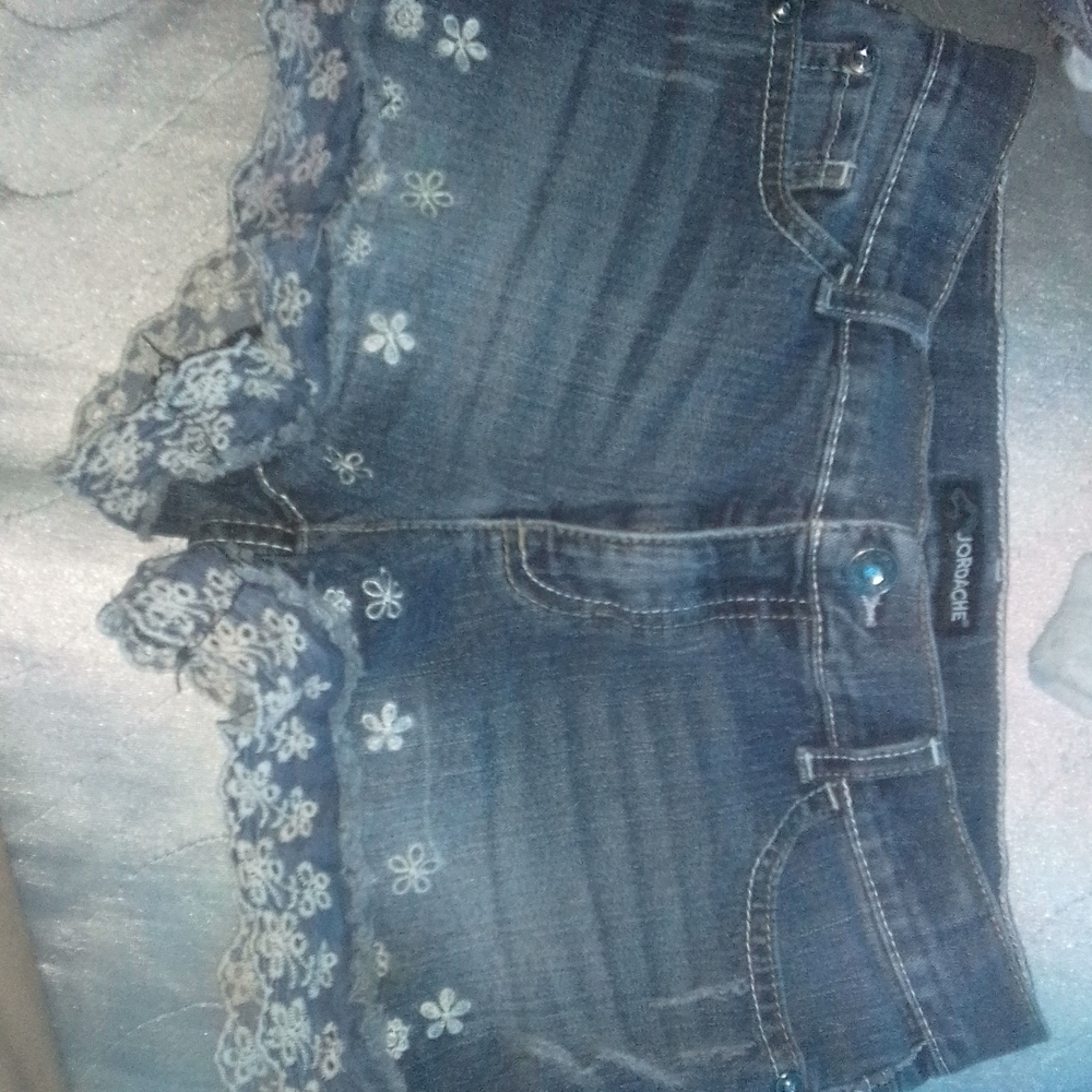 Dark denim jordache jeans with floral detail. Size 14 in children's.
